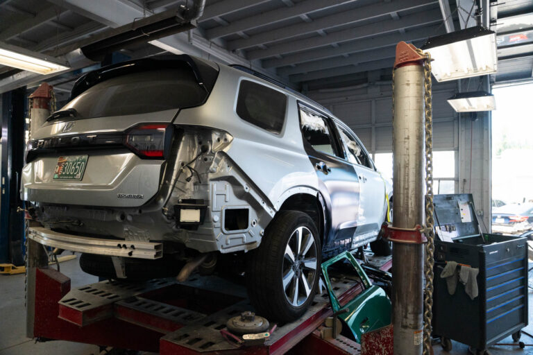 honda pilot on an auto lift getting auto body repair done after an accident